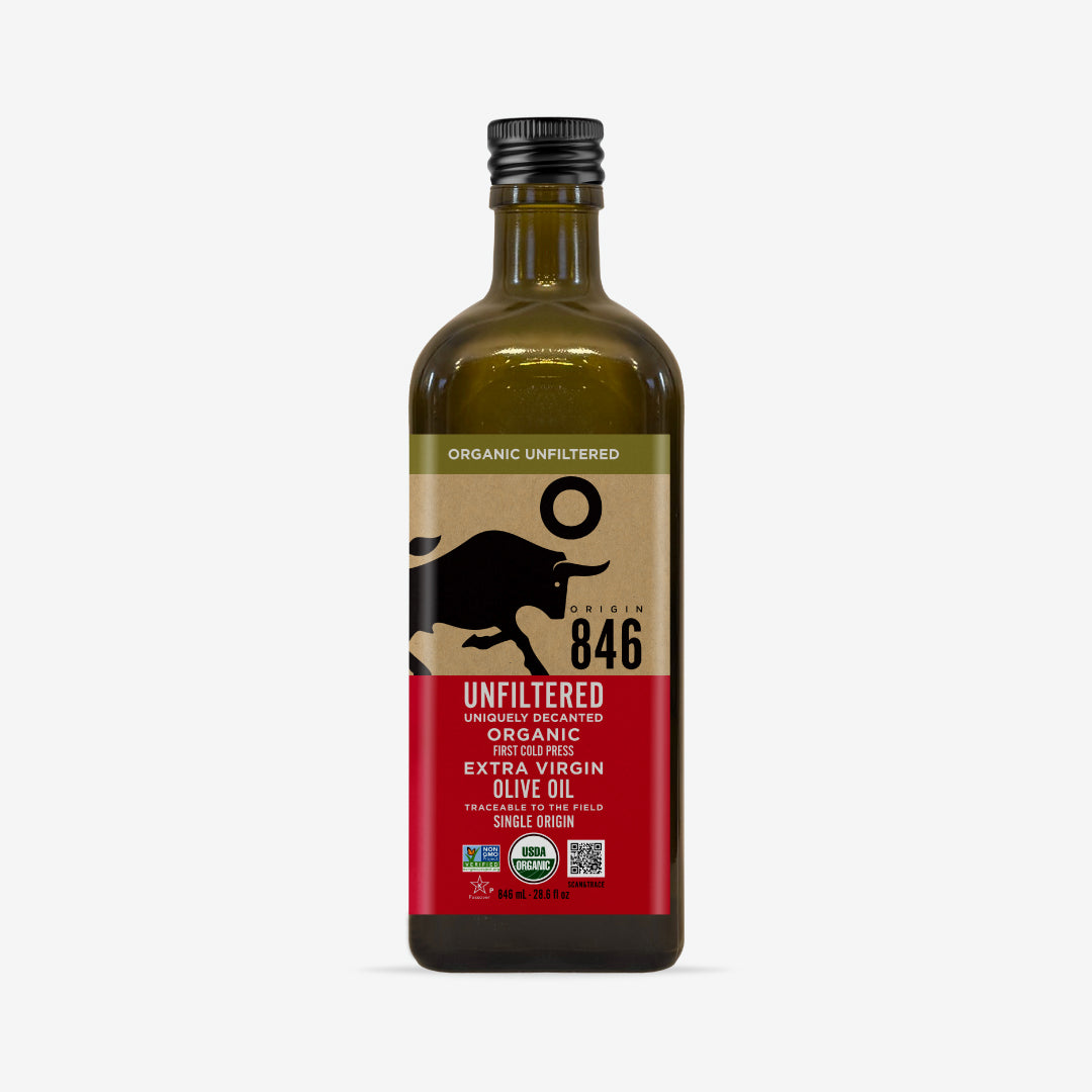 A front facing ark glass bottle of Origin 846 organic unfiltered extra virgin olive oil. The label has these call outs: First cold press, traceable to the filed, single origin. The certifications on the label are Non-GMO project verified, USDA organic, Kosher for Passover. There is a QR code with the call out Scan and trace. The size of the glass bottle is 846ml (28.6 fl oz)